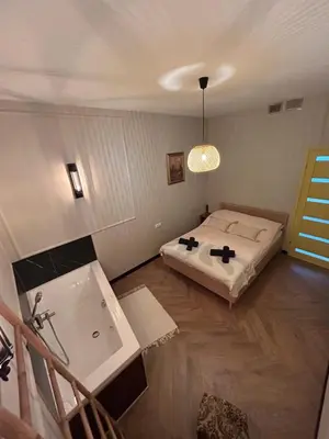 a bedroom with a bed and a sink and a tub at La Ville - Jaune in Zator