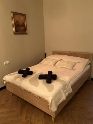 a bedroom with a bed with two black bows on it at La Ville - Jaune in Zator