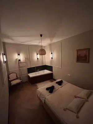 a hotel room with a bed and a bath tub at La Ville - Jaune in Zator