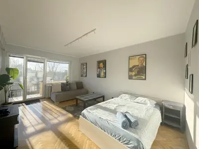 a bedroom with a bed and a painting on the wall at Fenna loft in Kraków