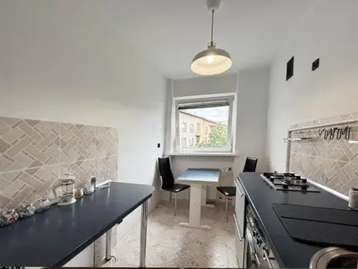a kitchen with a counter and a table and a table at Fenna loft in Kraków
