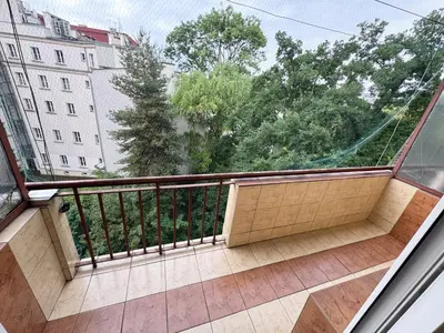 a hallway with a door and a living room at Fenna loft in Kraków