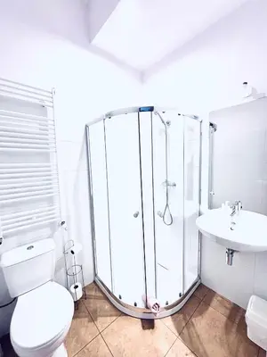 a bathroom with a shower and a toilet and a sink at Gościniec i Restauracja Salton in Bochnia