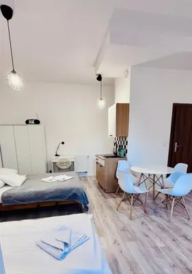 a bedroom with a bed and a table and chairs at Gościniec i Restauracja Salton in Bochnia