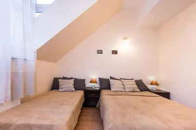 two beds sitting next to each other in a room at Vanilla 1, 2bdr 2bth 5min to Main Square in Kraków
