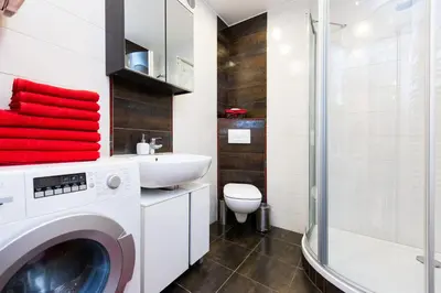 a bathroom with a washing machine and a sink at Vanilla 1, 2bdr 2bth 5min to Main Square in Kraków