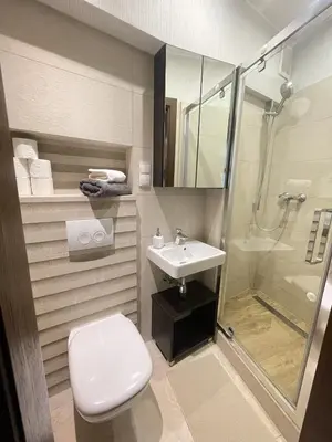 a bathroom with a toilet and a sink and a shower at Vanilla 1, 2bdr 2bth 5min to Main Square in Kraków