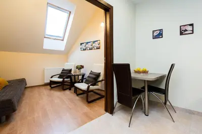 a small living room with a table and chairs at Vanilla 1, 2bdr 2bth 5min to Main Square in Kraków