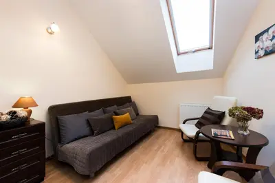 a living room with a couch and a table at Vanilla 1, 2bdr 2bth 5min to Main Square in Kraków