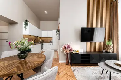 a kitchen and living room with a table and chairs at LIFESTYLE Apartments in Bochnia
