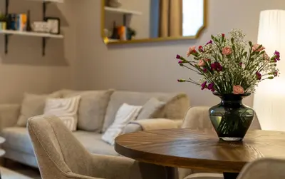 a vase of flowers on a table in a living room at LIFESTYLE Apartments in Bochnia