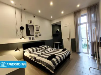 a bedroom with two beds in a room at Fantastic-Inn Kraków - Słowackiego in Kraków