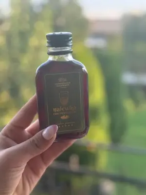 a person holding a bottle of syrup in their hand at Terenowka Bacowka in Waksmund