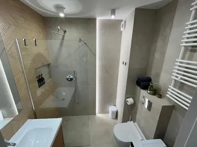 a bathroom with a shower and a toilet and a sink at Nowy apartament Saska, z parkingiem in Kraków