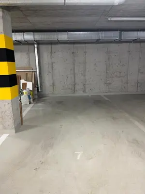 an empty parking garage with a yellow and black pole at Nowy apartament Saska, z parkingiem in Kraków