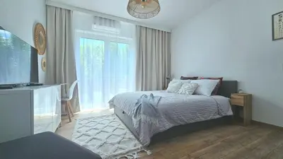 a bedroom with a bed and a large window at Blue Salt in Wieliczka