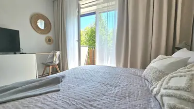 a bedroom with a bed and a large window at Blue Salt in Wieliczka