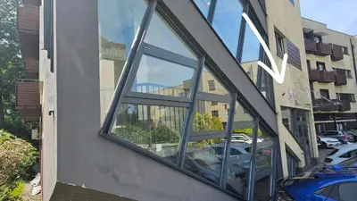a window on the side of a building with cars in it at Blue Salt in Wieliczka