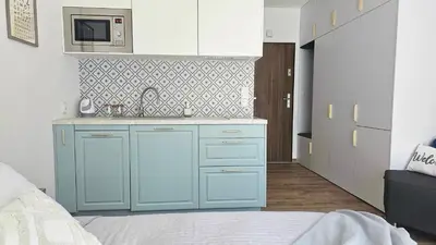 a blue kitchen with a sink and a bed at Blue Salt in Wieliczka