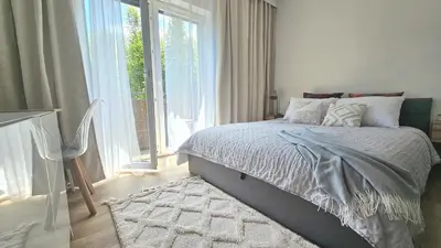 a bedroom with a bed and a large window at Blue Salt in Wieliczka