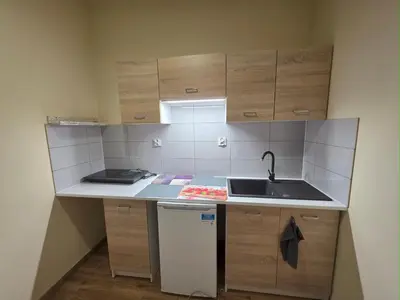 a small kitchen with a sink and a counter at Mieszkanie 3 in Kraków