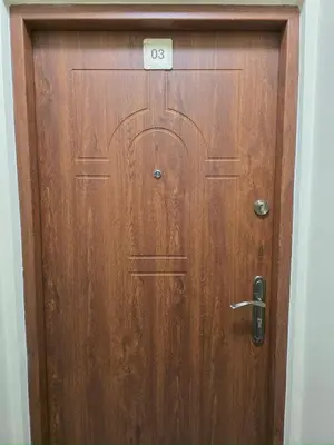 a wooden door with the number on it at Mieszkanie 3 in Kraków