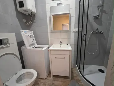 a bathroom with a shower and a toilet and a sink at Mieszkanie 3 in Kraków