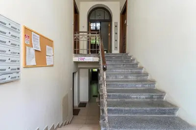 a stairway in a building with a stair case at Park Krakowski Comfy Studio by BookingHost in Kraków