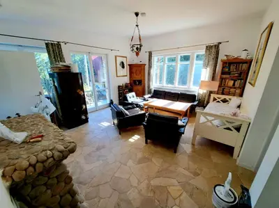 a living room with a couch and a table at Dom z tarasem wśród pól i lasu - przestronny salon, blisko natury in Lubień