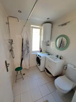 a bathroom with a toilet and a sink and a mirror at Dom z tarasem wśród pól i lasu - przestronny salon, blisko natury in Lubień