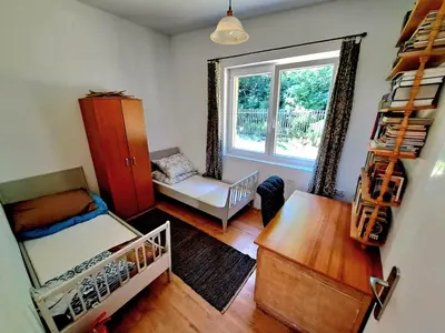 a small room with a bed and a window at Dom z tarasem wśród pól i lasu - przestronny salon, blisko natury in Lubień