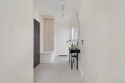 a hallway with a table and a white hallway at Prandoty Stylish Apartment with Balcony & Parking in Cracow Old Town by Renters Prestige in Kraków