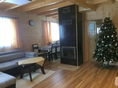 a living room with a christmas tree and a couch at Domek z widokiem na góry in Targoszów