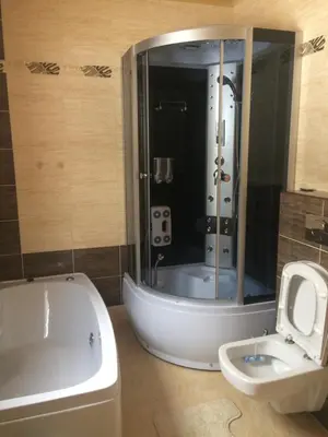 a bathroom with a shower and a tub and a toilet at Domek z widokiem na góry in Targoszów