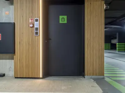 a door in a building with a green sign on it at Nice time in Hart of Cracow,Gym&Pool&Sauna and free parking in Kraków