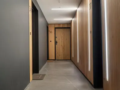 a hallway with wooden doors and a tile floor at Nice time in Hart of Cracow,Gym&Pool&Sauna and free parking in Kraków