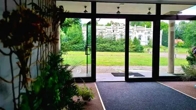 an open door to a yard with a building at Zielona Paszkówka - sauna! in Paszkówka