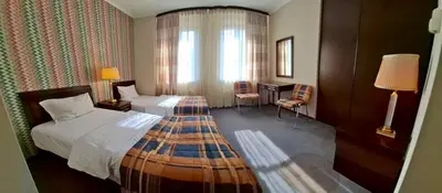 a hotel room with two beds and a window at Zielona Paszkówka - sauna! in Paszkówka