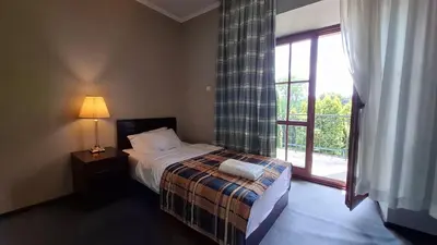 a bedroom with a bed and a large window at Zielona Paszkówka - sauna! in Paszkówka