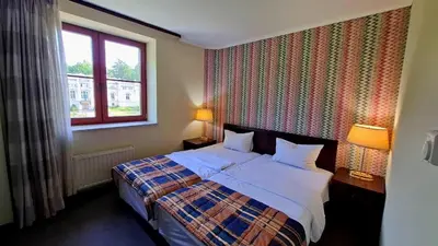 a bedroom with a bed and a window at Zielona Paszkówka - sauna! in Paszkówka