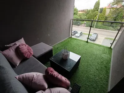 a living room with a couch and a table and a balcony at Apartament Maria in Oświęcim