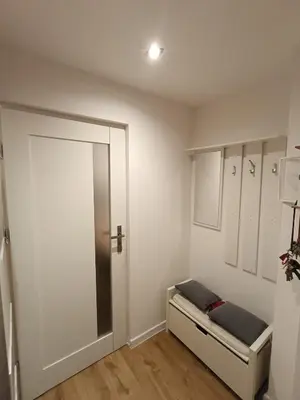 a room with a bed with a mirror and a door at Apartament Maria in Oświęcim