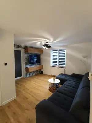a living room with a couch and a table at Apartament Maria in Oświęcim