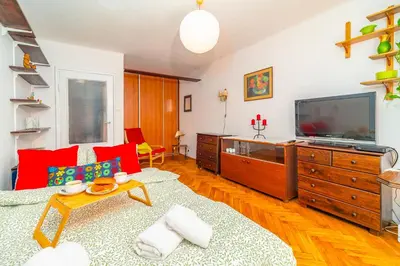 a living room with a couch and a tv at Kraszewskiego Apt - Balcony, Park & River nearby - by Rentujemy in Kraków