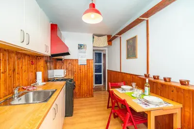 a kitchen with a table with chairs and a sink at Kraszewskiego Apt - Balcony, Park & River nearby - by Rentujemy in Kraków