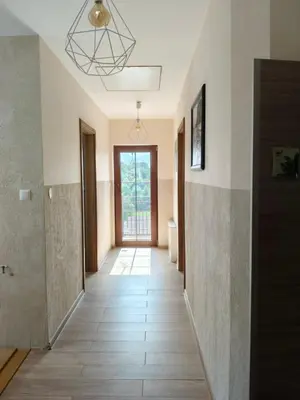 a hallway of a house with a door and a tile floor at Słoneczne apartamenty Zator blisko Energylandii in Zator