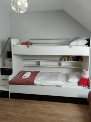 a bedroom with a white bunk bed with a red blanket at Słoneczne apartamenty Zator blisko Energylandii in Zator