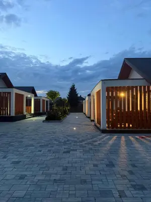 a building with a courtyard at dusk at Zator Domki Dreampark in Zator