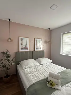 a bedroom with a large white bed with towels on it at Zator Domki Dreampark in Zator