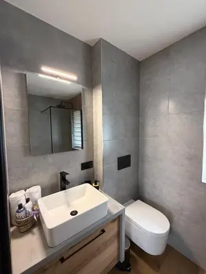 a bathroom with a white sink and a toilet at Zator Domki Dreampark in Zator